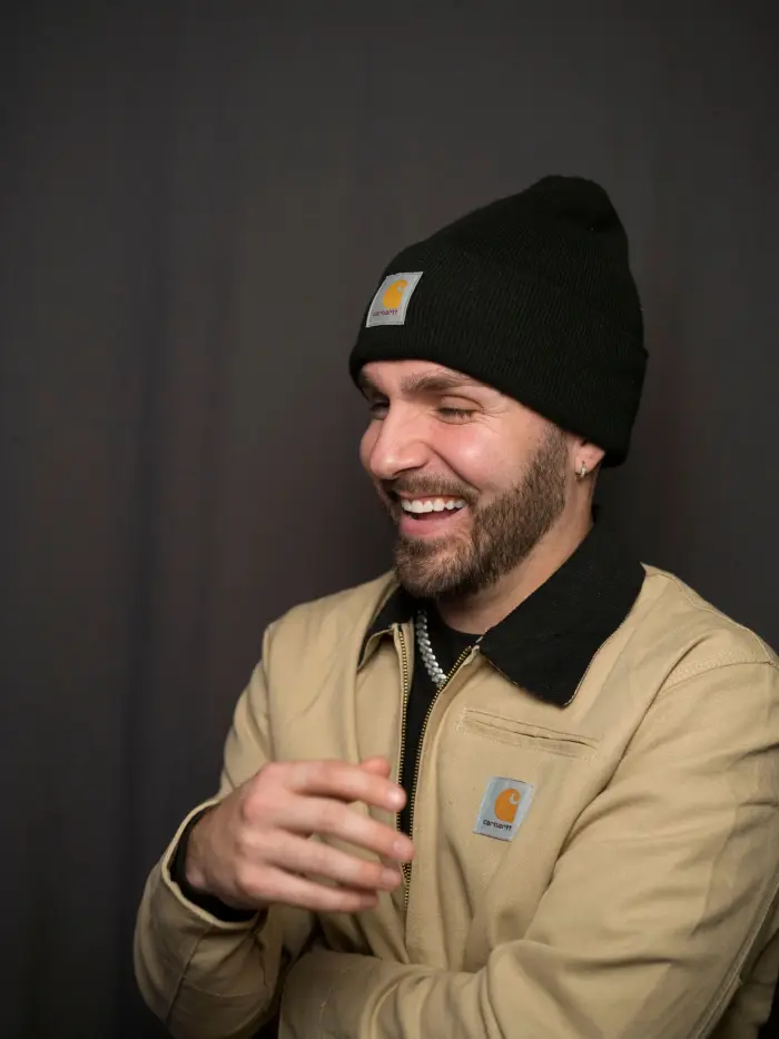 Cody in a studio portrait, laughing