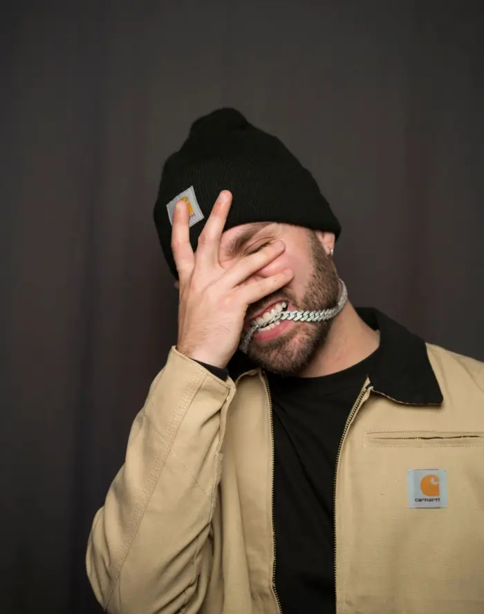 Cody with his hand over his face