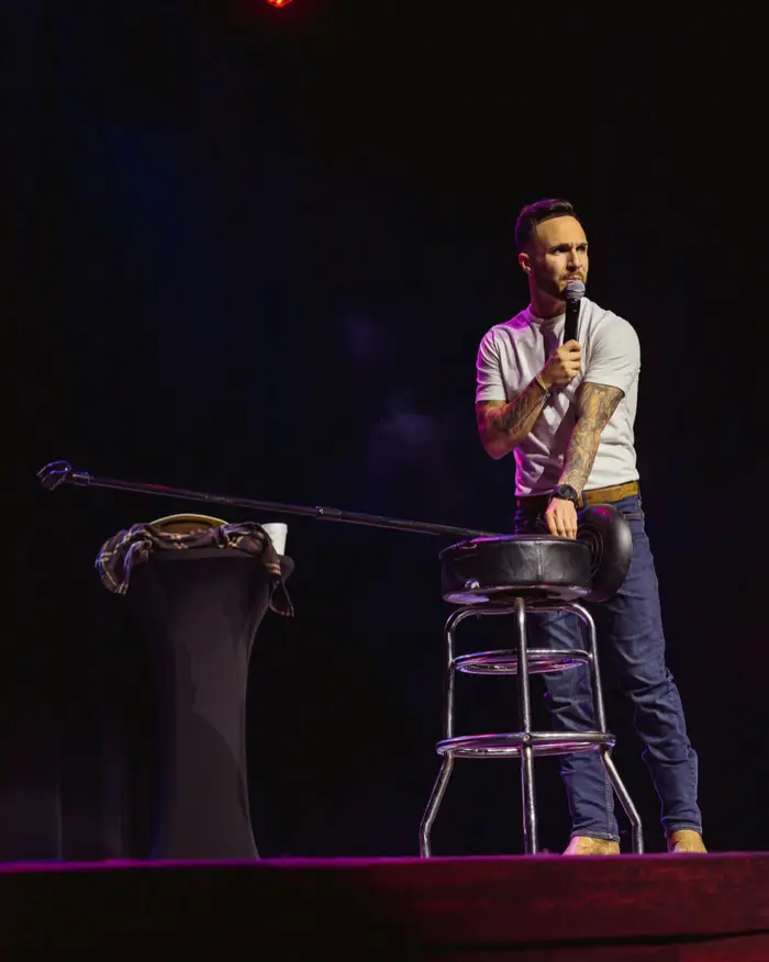 Cody on stage on a stool