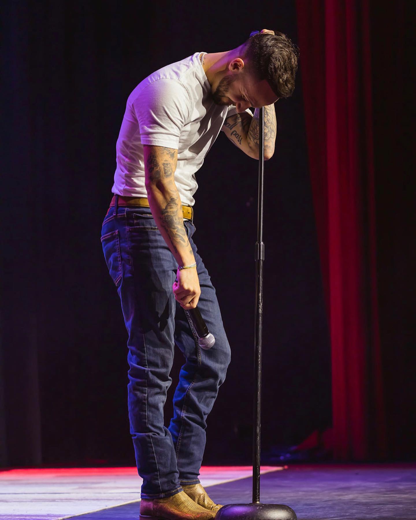 Cody performing with red curtain